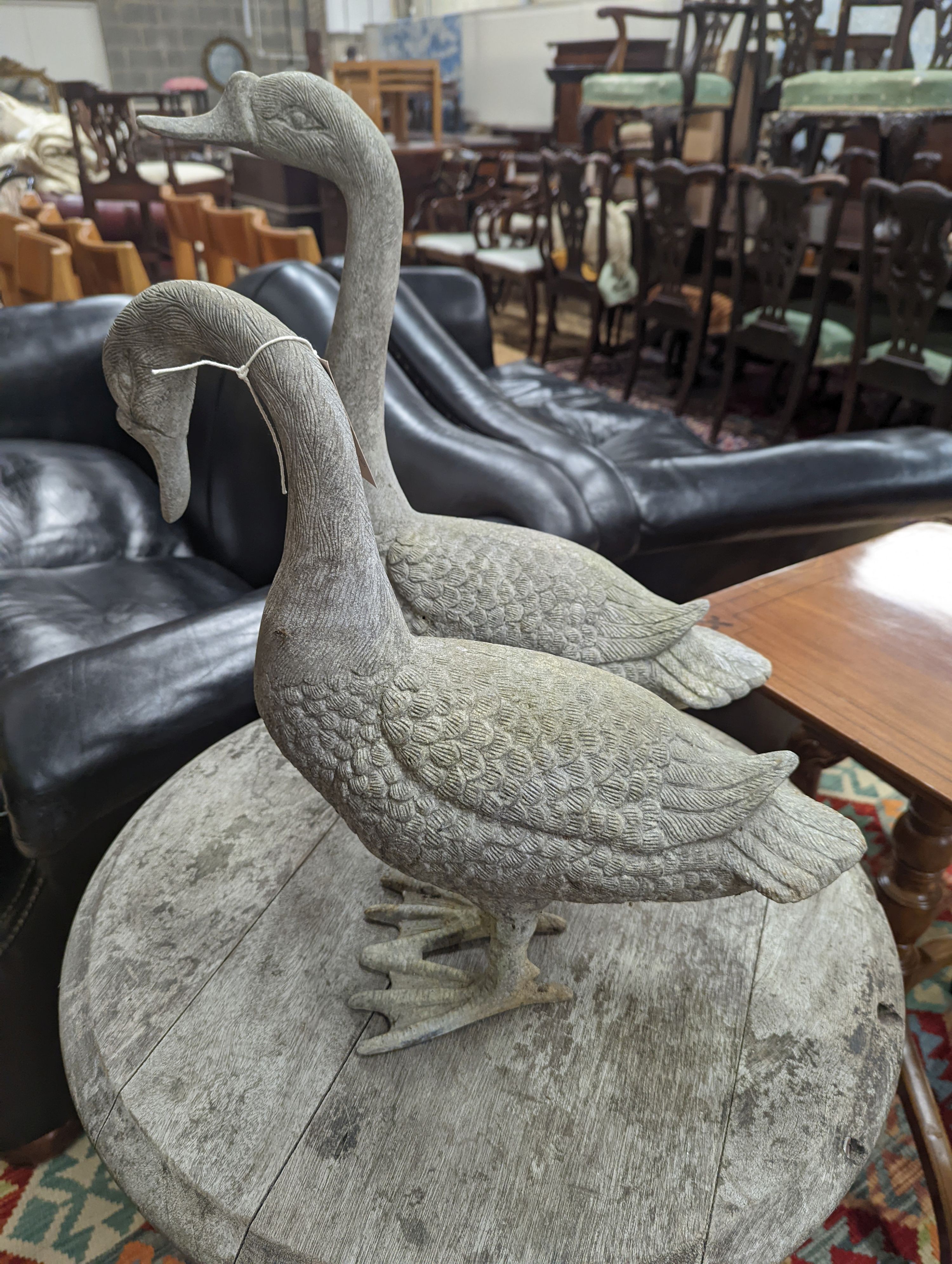 A pair of cast metal garden ornaments modelled as geese, larger height 51cm